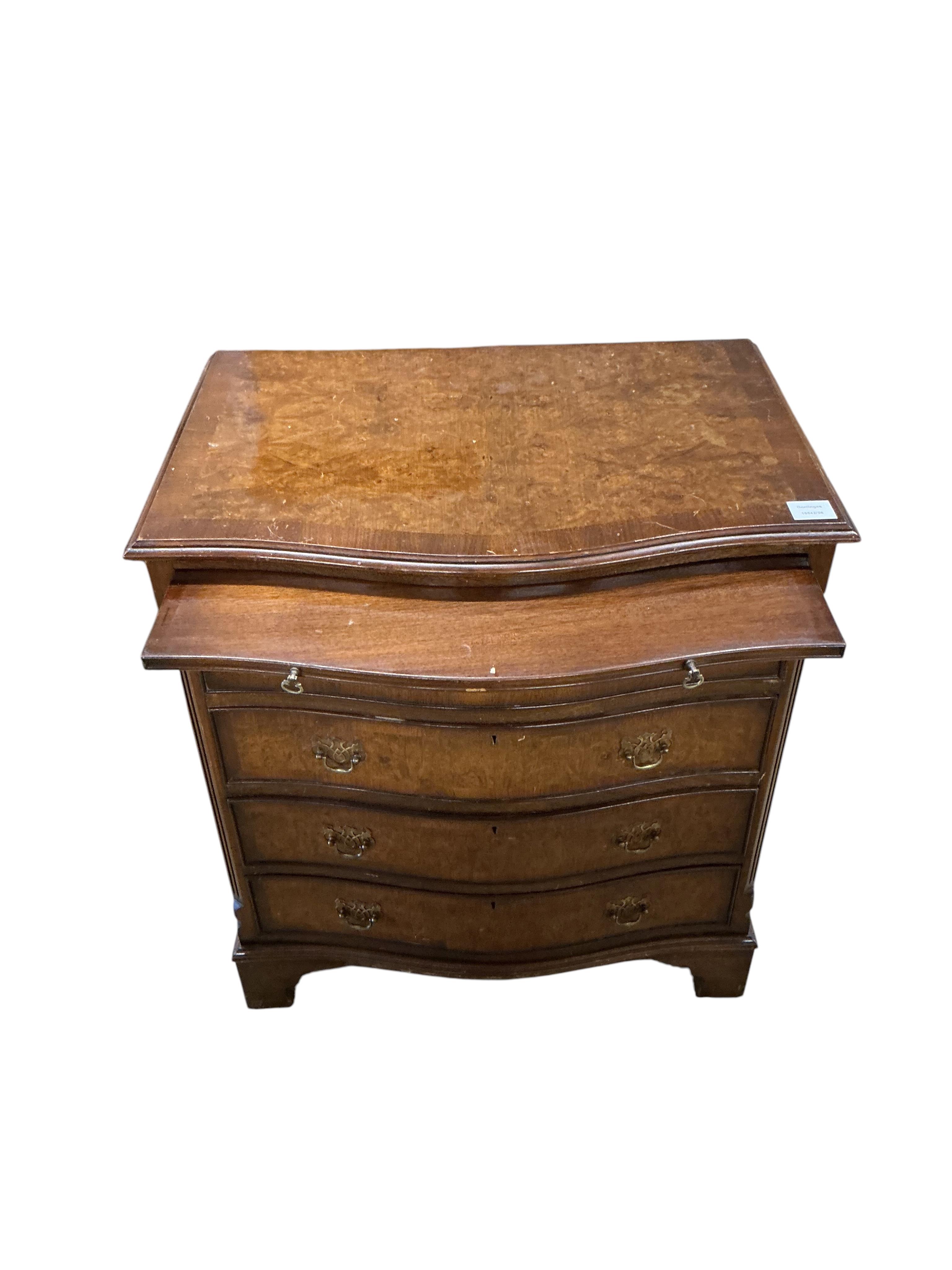A reproduction George I style walnut serpentine four drawer chest, with brushing slide, width 70cm, depth 48cm, height 77cm